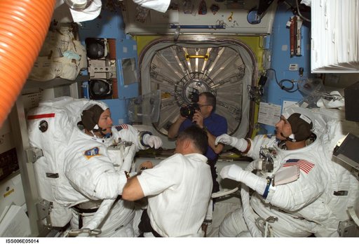 STS-113 Pilot Lockhart is assisting MS Lopez-Alegria and MS Herrington with their EMU Spacesuits