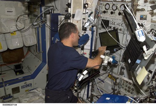 Expedition Six Flight Engineer Donald R. Pettit is loading software on PC in U.S. Lab