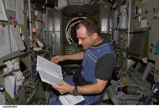 Expedition Six Flight Engineer Pettit is looking at procedures checklist in the Zvezda Service Module