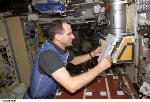 Expedition Six Flight Engineer Pettit is looking at a procedures checklist