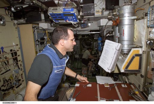 Expedition Six Flight Engineer Pettit is looking at a procedures checklist