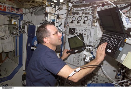 Expedition Six Flight Eng Donald R. Pettit is setting up the Pulmonary Function in Flight hardware