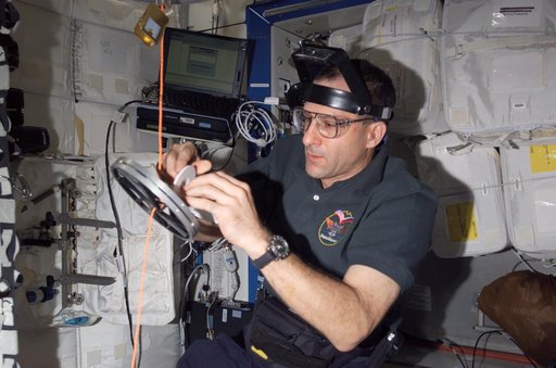 Pettit conducts maintenance on the RED equipment in the U.S. Laboratory
