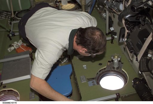 Budarin looks through a nadir window in the Service Module