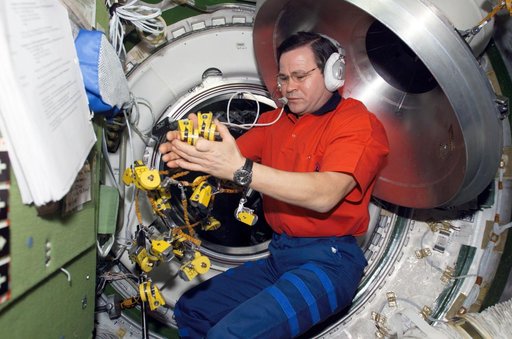 Budarin works with clamps in the Transfer Chamber of Zvezda during Expedition Six