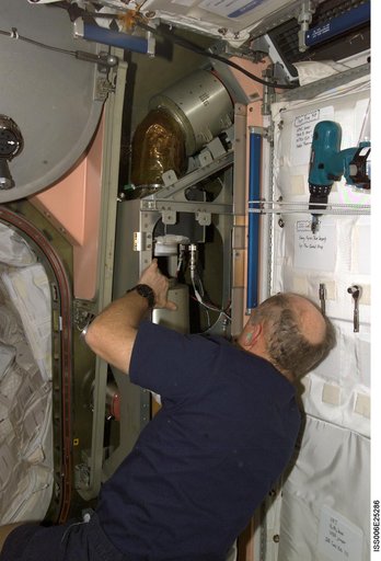 Bowersox works on the IMV system in Node 1 during Expedition Six