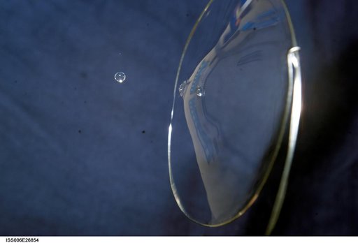 View of a surface tension demonstration using water that is being held in place by a 50mm metal loop