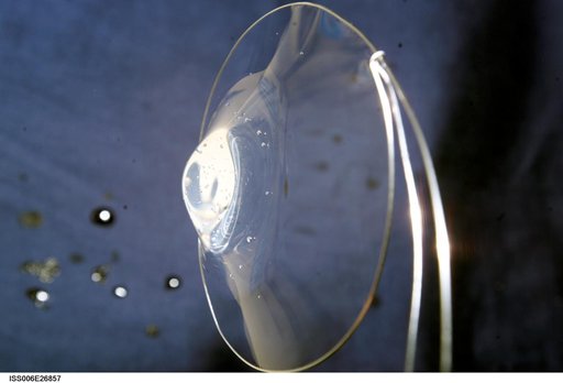 View of a surface tension demonstration using water that is being held in place by a 50mm metal loop