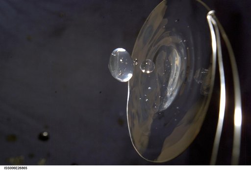 View of a surface tension demonstration using water that is being held in place by a 50mm metal loop