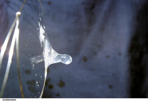 View of a surface tension demonstration using water that is being held in place by a 50mm metal loop