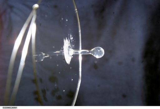 View of a surface tension demonstration using water that is being held in place by a 50mm metal loop