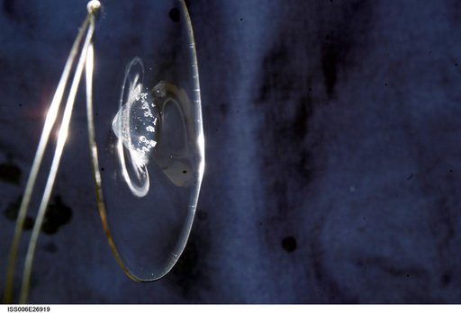 View of a surface tension demonstration using water that is being held in place by a 50mm metal loop