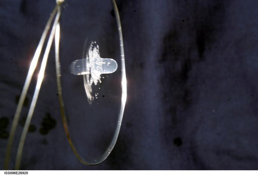 View of a surface tension demonstration using water that is being held in place by a 50mm metal loop