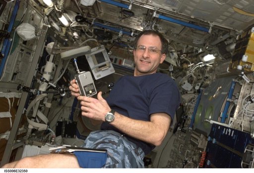 Flight Engineer Donald R. Pettit holds a CPU440 as he poses in the U.S. Laboratory