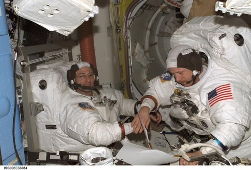 Bowersox and Pettit participate in a scheduled EVA DTO in the Quest Airlock during Expedition Six