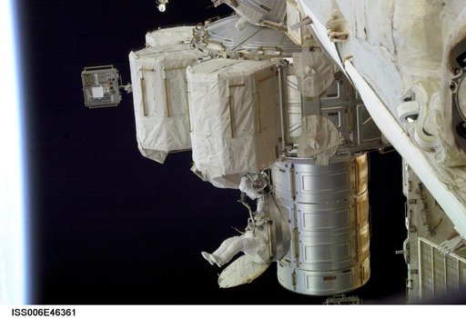 View of Flight Engineer Donald R. Pettit emerging from the Quest/Airlock to perform tasks