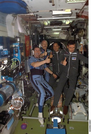 Expedition Seven crewmembers pose with two of the Expedition Six crewmembers in the SM