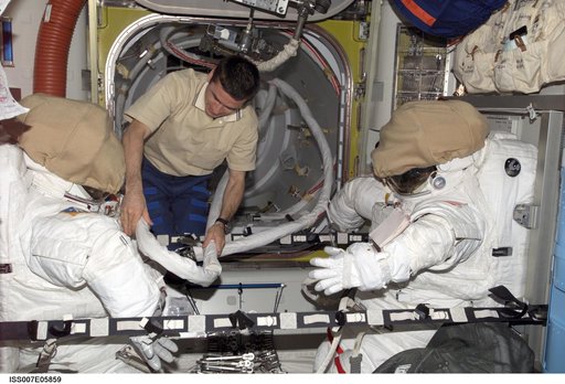 Expedition Seven CDR Malenchenko in Quest airlock with EMUs