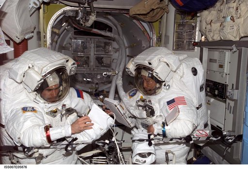 Expedition Seven CDR Malenchenko and Science Officer Lu in Quest airlock with EMUs