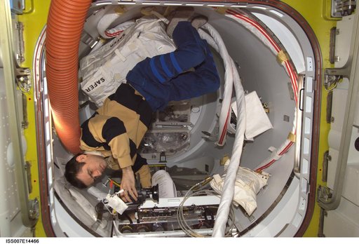 Expedition Seven Malenchenko with video camera in Quest airlock