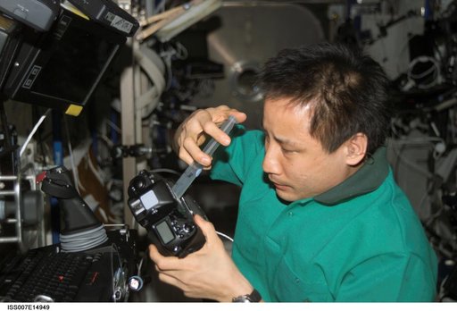 Expedition Seven Lu performs maintenance on camera
