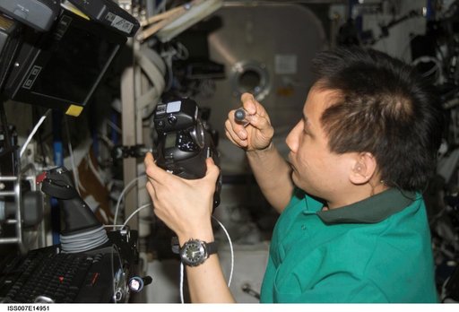 Expedition Seven Lu performs maintenance on camera