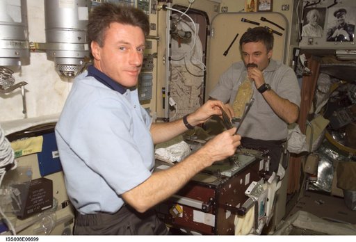 Foale and Kaleri during a meal in the galley area of the SM during Expedition 8