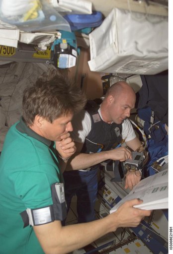 Padalka and Kuipers review a procedures book in Node 1 during EXP 9 / EXP 8