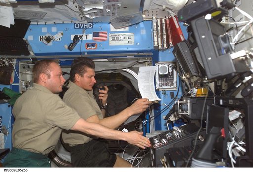 Padalka and Fincke participate in planning conference with Mission Control in the U.S. Laboratory during Expedition 9