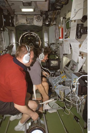 Fincke watches as Padalka at the Simvol-Ts workstation during Progress 14P docking approach OPS on Expedition 9