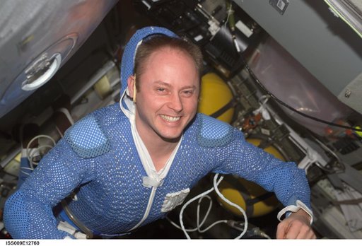 Fincke smiles at the camera before donning his EVA suit in the DC during Expedition 9