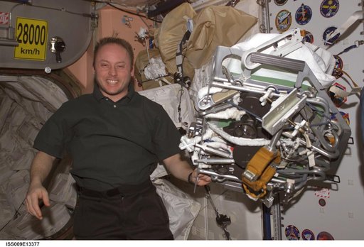 Fincke poses with a packed EVA tool and gear bundle in Node 1 during Expedition 9