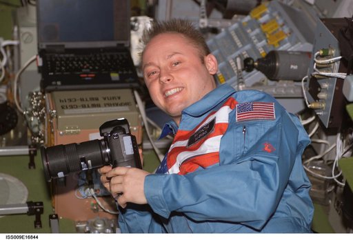 Fincke holds a digital camera in the SM during Expedition 9