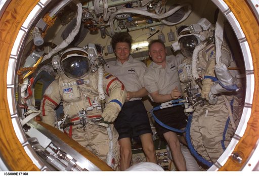 Padalka and Fincke pose with their Orlan Suits inside the Docking Compartment during Expedition 9