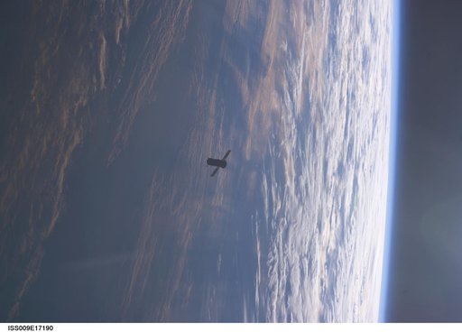 Progress Spacecraft moves away from the station after undocking taken during Expedition 9