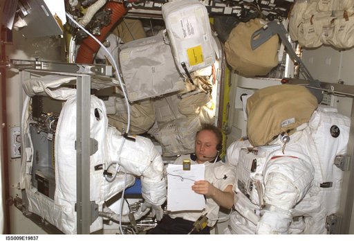 Fincke conducts cooling tests on EMU during repair operations in the A/L on Expedition 9