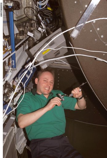 Fincke unbolts the front panel of the CHeCS Rack for inspection and cleaning during Expedition 9