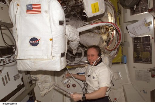 Fincke performs EMU water sample and flushing operations in the A/L during Expedition 9