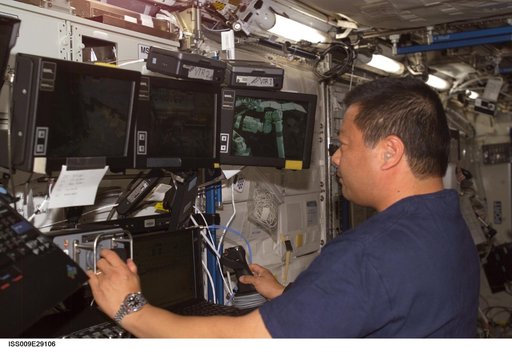 Chiao works at the SSRMS workstation as he performs Robotic Handover OPS during Expedition 9/10 joint OPS