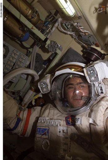 Sharipov wearing an EMU in the Airlock during Expedition 10