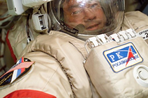 Sharipov wearing an EMU in the Airlock during Expedition 10