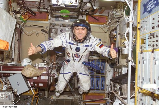 Sharipov wearing Sokol suit poses for photo in SM taken during Expedition 10