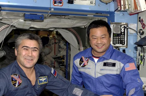 Sharipov and Chiao pose at the hatch area in the U.S. Laboratory during Expedition 10