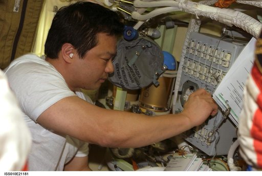 Chiao makes adjustment on the Russian Orlan Interface Unit in the Pirs DC1 during Expedition 10