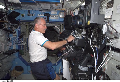 Phillips at the SSRMS controls in the U.S. Laboratory during Expedition 10 / Expedition 11