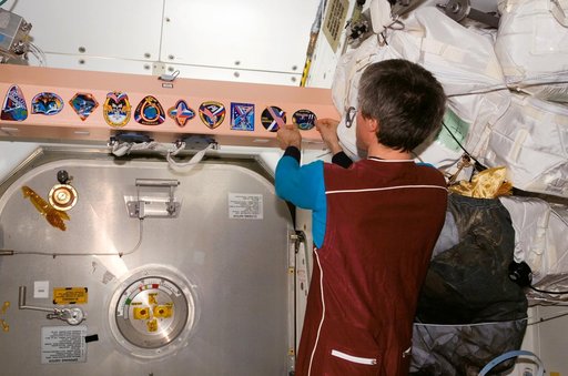 Krikalev with mission patch in Node 1 / Unity module