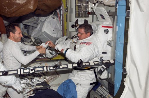 Tokarev and McArthur conduct an EMU don/doff practice during Expedition 12