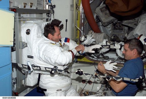 Tokarev and McArthur conduct an EMU don/doff practice during Expedition 12