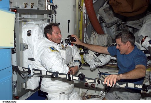 Tokarev and McArthur conduct an EMU don/doff practice during Expedition 12
