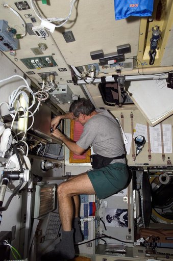 McArthur prepares to clean a ventilation filter screen inside the SM during Expedition 12